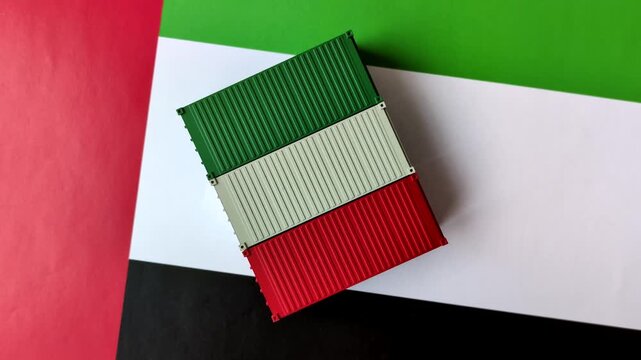 Cargo containers on the uae flag as a conceptual backdrop for goods export and logistics. Cargo containers on the uae flag as a background for your design