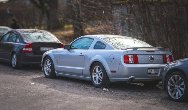 Gothenburg, Sweden - March 20 2026: Silver sports coupe parked along street with other cars in urban setting.