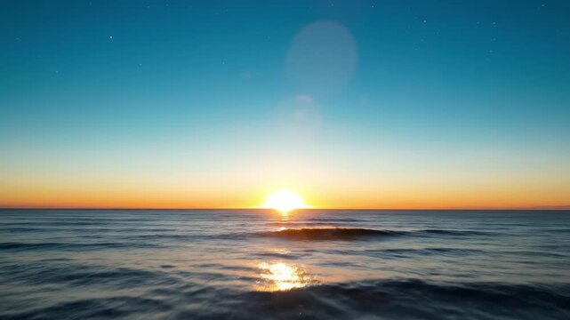 Star-filled predawn seascape with dark rolling water, luminous twilight band, crisp horizon line, and celestial calm above the ocean just before sunrise brightens the sky with quiet marine wonder