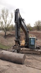 Profil koparki gąsienicowej Volvo na placu budowy: ciężkie maszyny budowlane podczas robót ziemnych i niwelacji terenu w plenerze. © tomo81