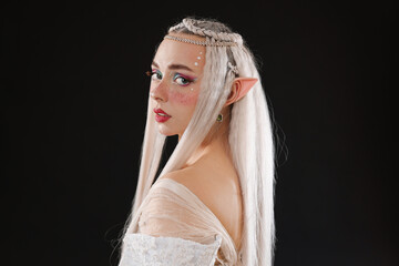 Naklejka premium Portrait of beautiful elf girl on black background