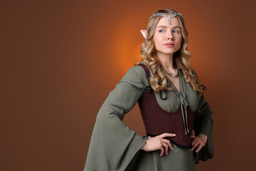 Naklejka premium Portrait of beautiful elf girl on brown gradient background, space for text