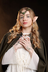 Naklejka premium Beautiful girl dressed as elf on dark background