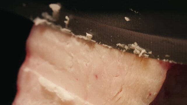 Raw lamb sheep fat tail fat on wooden board, close up of middle eastern pork or lamb dish. Rotating macro meat. 