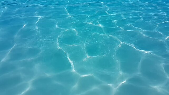 Clear water surface with sun glare and reflections background