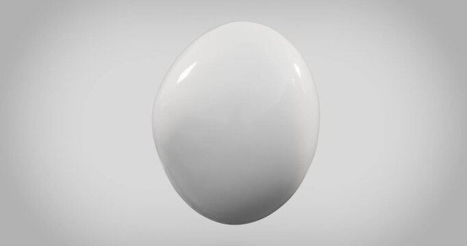 Glossy white egg on gray background looping animation