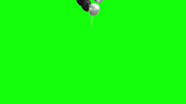 A cluster of black and silver glossy balloons floating upward against a bright green screen background