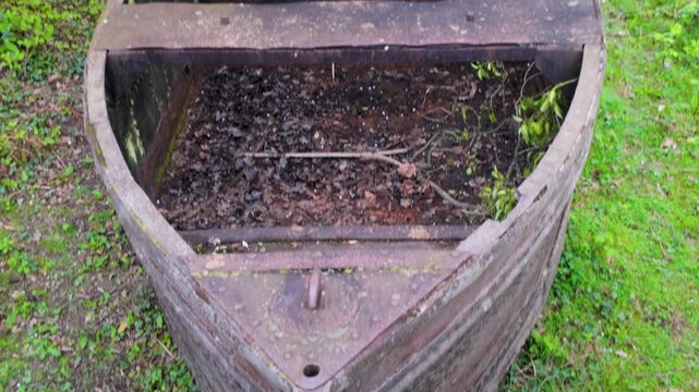 Rustic wooden boat repurposed as garden planter