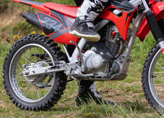 Off-road motorcycle on grass field in natural environment