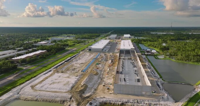 Development of commercial real estate in USA. Construction works on monolithic frame at large building site of logistics distribution warehouse.