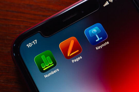 Quito, ECUADOR - Feb 3 2026 : Microsoft Office and Apple iWork App Icons on iPhone, Blue Green Background