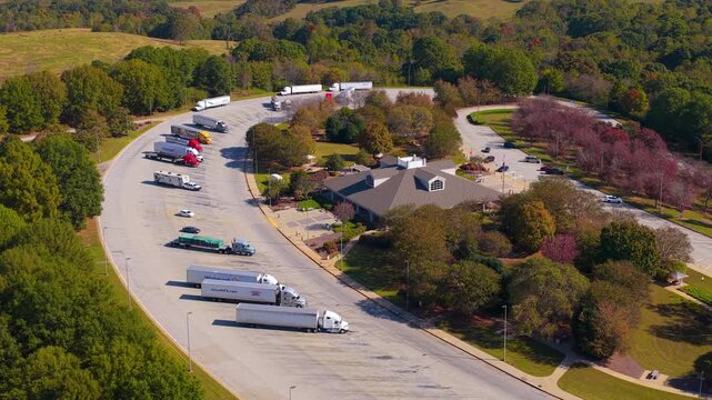 Large truck stop with resting area near busy American interstate freeway. Parking place during big rig interstate travel.