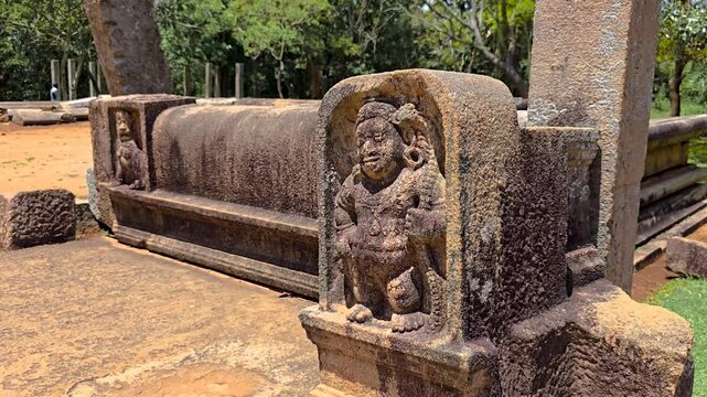 An ancient Muragala (guard stone) in Sri Lanka, featuring a Bahirava dwarf guardian with ornate carvings, traditionally placed at staircases of sacred and royal sites from the Anuradhapura era.