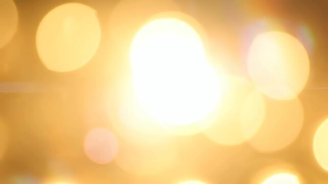 Bokeh Lights Create Warm Abstract Motion Scene of Soft Glowing Orbs and Golden Circles Across Frames in a Cinematic Glow