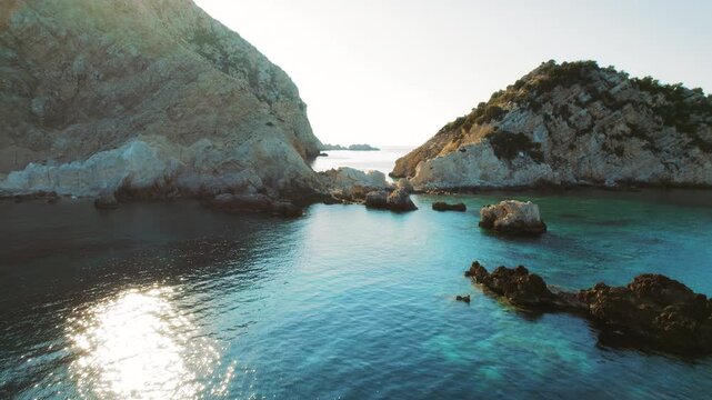 Sunset over rocky coastline and blue sea in summer Kefalonia Greece