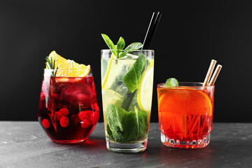 Obraz premium Different tasty refreshing cocktails on grey table