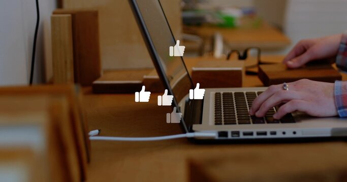 Typing hands in plaid shirt, ringed, pressing keys on laptop at wood table, showing like overlays
