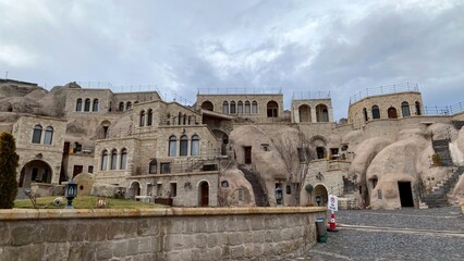 Fototapeta premium Cappadocia cave hotel exterior daytime Turkey stone architecture travel destination