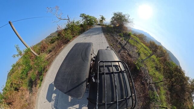 Scenic winding highway with mountain view in tiny planet style including surrounding sound