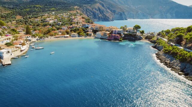 Colorful seaside village on a rocky peninsula during clear summer day in Greece