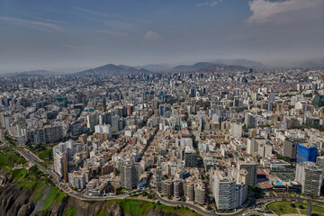 Fototapeta premium Aerial view of Miraflores and Costa Verde coastline in Lima, Peru, showcasing modern urban living along the Pacific Ocean with scenic cliffs, vibrant cityscape, and coastal landscapes. 