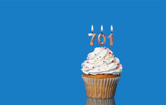 Birthday Or Anniversary Cupcake With Lit Candles; Candles Forming The Number 701