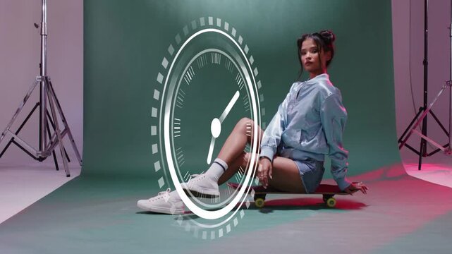 Responding to animated clock graphics, model shifting poses on skateboard in studio in blue jacket