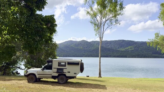 4WD vehicle parked at Lake Tinaroo in the Atherton Tablelands, tropical North Queensland, Australia. Scenic freshwater lake with outdoor adventure and travel concept.