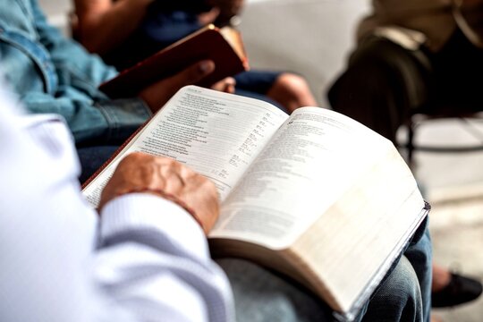 Group reading open Bible together.
