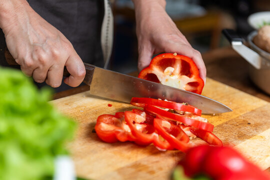 Slicing fresh red bell pepper