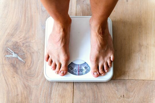 Feet on scale measuring weight