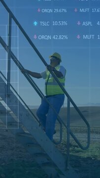 Vertical video: Worker stepping on construction stairs, inspecting site as charts overlaying frame
