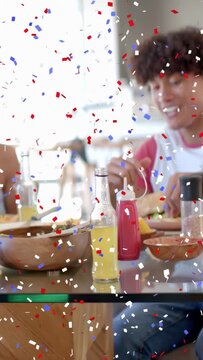 Vertical video: He turning reaching she joining laughing sharing meal food ad table confetti moving
