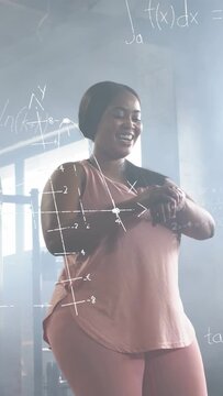 Vertical video: Pink woman tapping watch and showing plots tracking fitness while pal enters waving