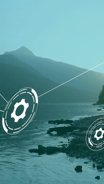 Vertical video: Large gear rotating in from left sending lines, gears, forming tech network on lake