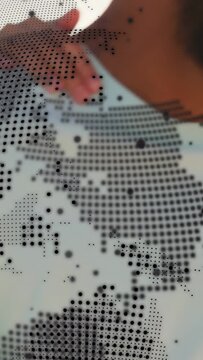 Vertical video: Dotted globe overlay shifting, revealing friends posing for travel selfie on beach