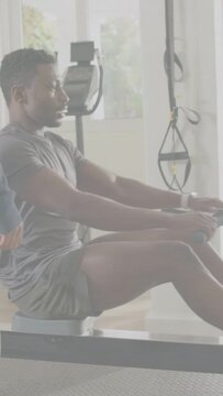 Vertical video: Fitness rower starting pull on coach cue, pulling to chest and folding into squat