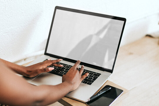 Typing hands on laptop photo