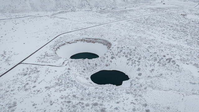 Poza de las &Aacute;nimas and Route 222 covered in snow, aerial winter view near Las Le&ntilde;as, Mendoza, Argentina.