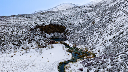 Aerial view of Laguna de la Nina Encantada with snowy volcanic crater in Mendoza Argentina.  © Marcio Eneas