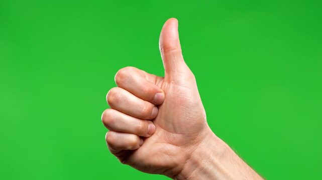 A human hand giving a thumbs up gesture against a vibrant green screen background, symbolizing approval or success.