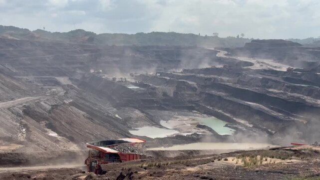 Massive Open Pit Coal Mining Operation with Heavy Dump Trucks