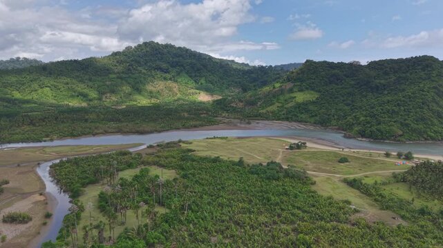 Aerial drone footage moving to the right over Muara Mbaduk river mouth in Banyuwangi, Indonesia,