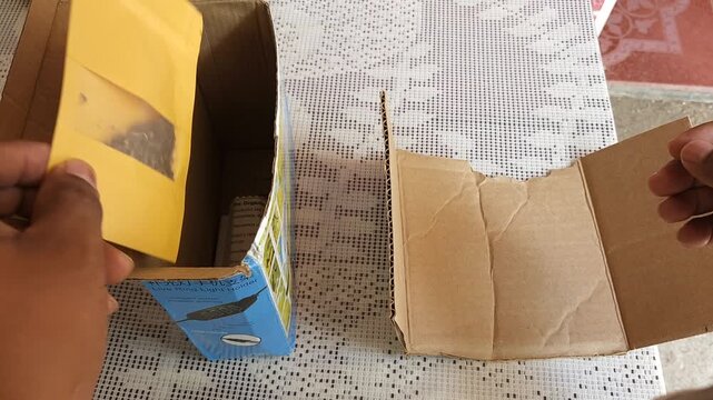 Preparing a yellow envelope with chipilin seeds for shipping