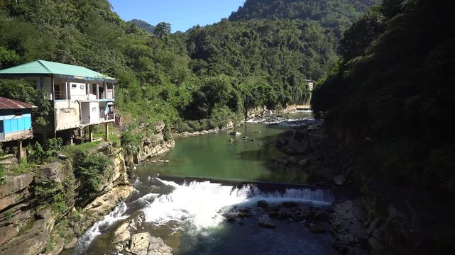 A fast-flowing river flows between two mountains in Mizoram