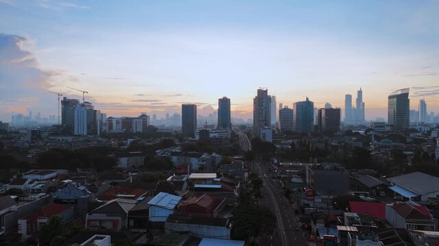 Aerial city skyline at dusk with highrise buildings.