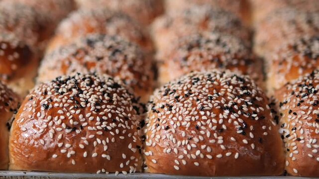 Freshly baked bread rolls on a tray