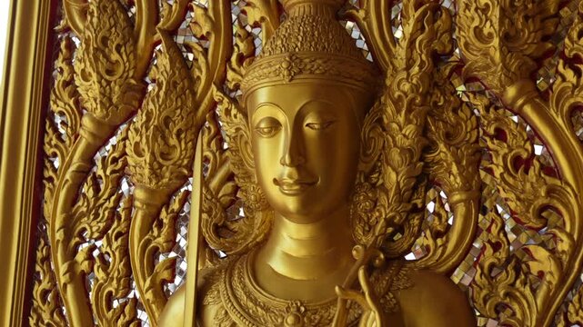 Close view ornate temple door golden thepphanom figure high relief layered carving sacred Thai ornament craftsmanship.