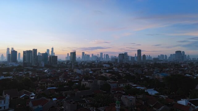City skyline at dawn with high rise buildings.