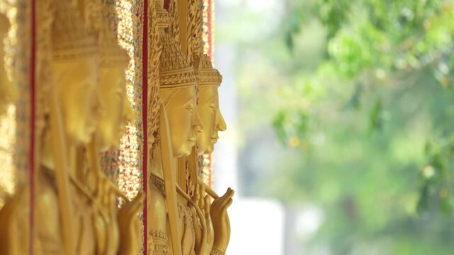 Close view ornate temple door golden thepphanom figure high relief layered carving sacred Thai ornament craftsmanship.